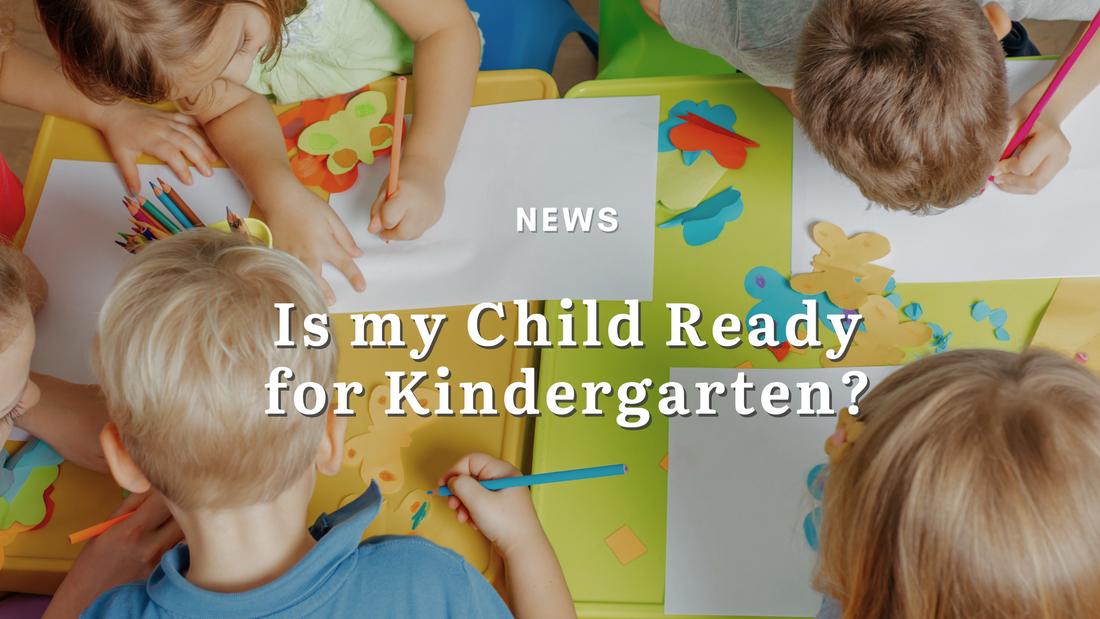 5 year old kindergarten children gather round a table, drawing with brightly colored pencil crayons